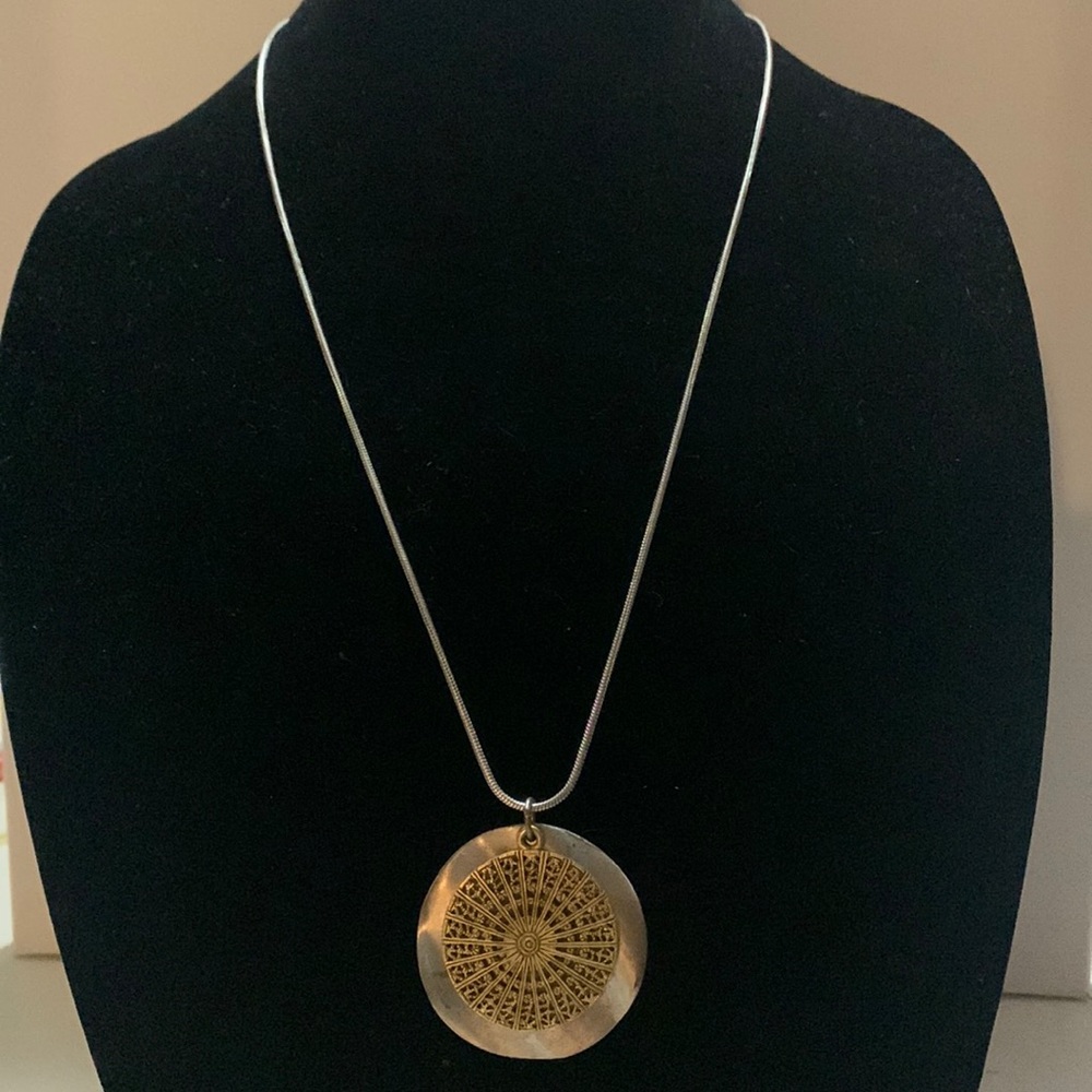 Women’s necklace, silver chain, gold and silver layered medallions.